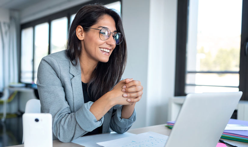 Confident business woman on a video conference with laptop in the office