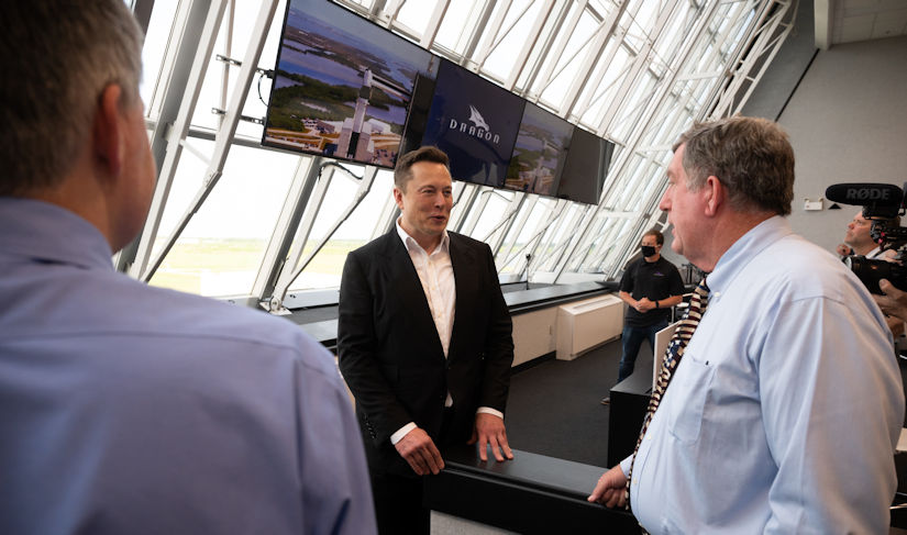 Elon Musk, SpaceX Chief Engineer, speaks with NASA International Space Station Program Manger Kirk Shireman, after the launch of a SpaceX Falcon 9 rocket