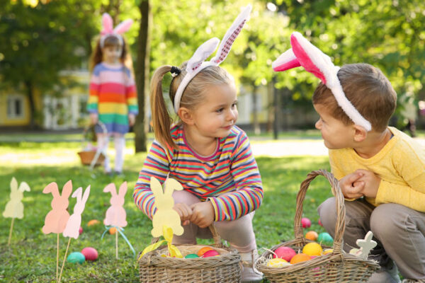 Cute little children on a Easter egg hunt in the park