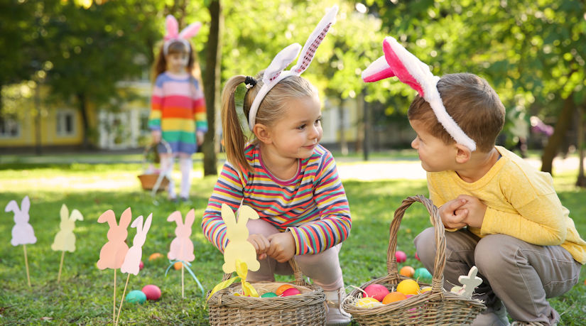Cute little children on a Easter egg hunt in the park