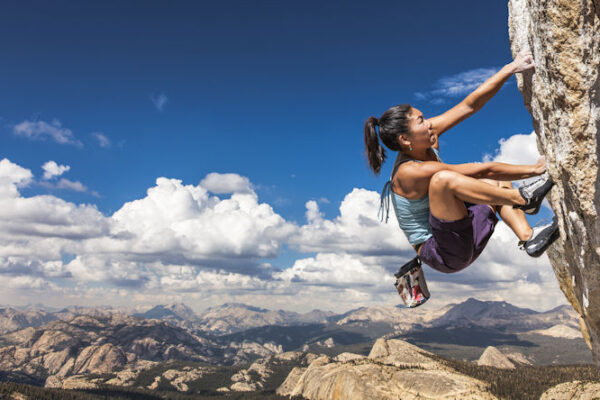 Rock climber clinging to a cliff.